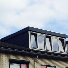 Zwarte dakkapel witte woning